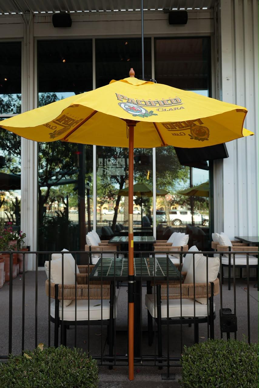 The Lomas patio with a yellow Pacífico umbrella